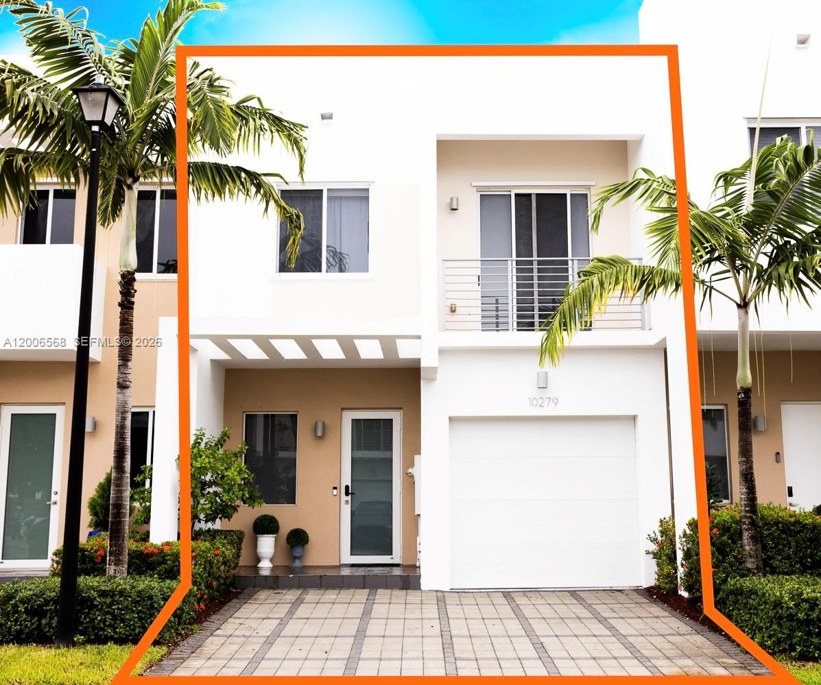 A two-story townhouse exterior features a white facade, a single-car garage, and a balcony — 10279 NW 72nd St, Doral FL 33178, DORAL, FL