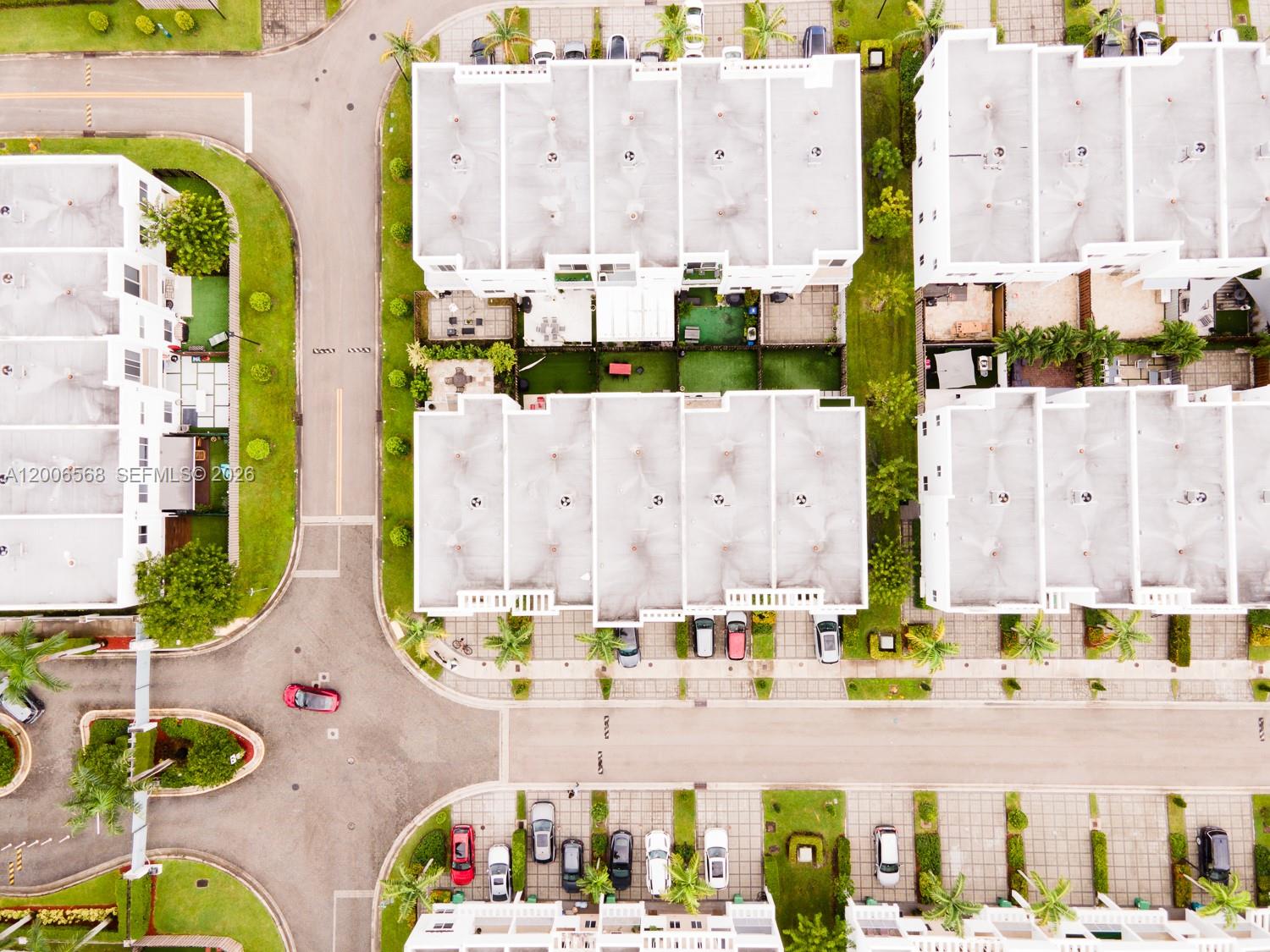 This aerial view shows a residential neighborhood with townhouses, parking spaces, and landscaped green areas — 10279 NW 72nd St, Doral FL 33178, DORAL, FL