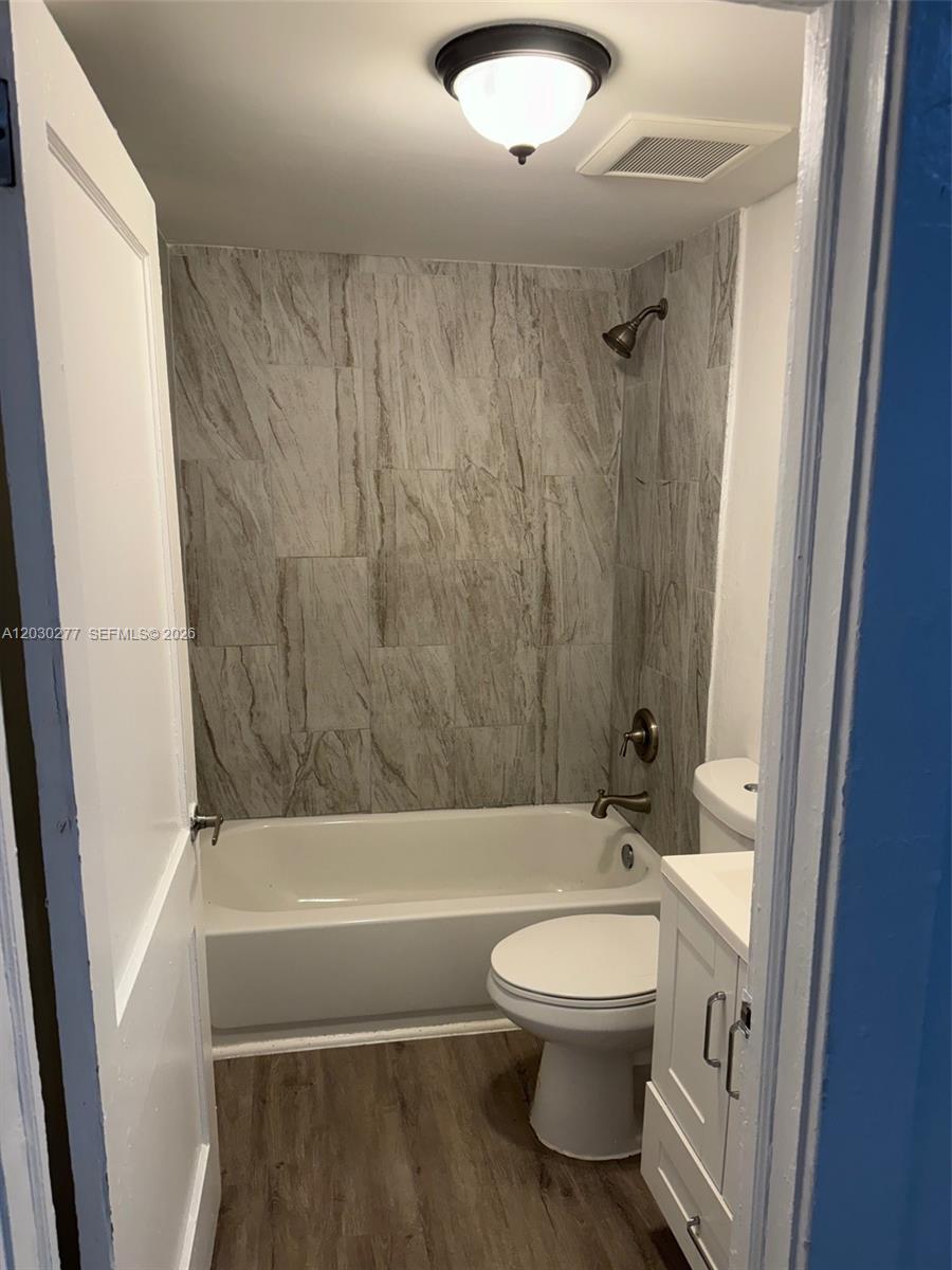 A small bathroom features a white bathtub, a tiled shower wall, and a vanity — 1552 SW 2nd St # 3, Miami FL 33135, MIAMI, FL