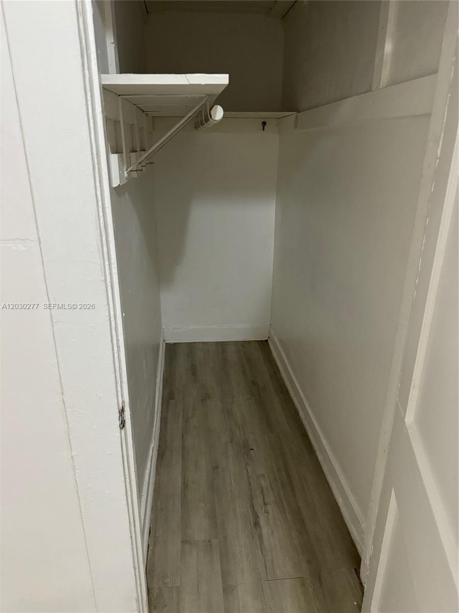 This is a small, empty walk-in closet with white walls and light wood-look flooring — 1552 SW 2nd St # 3, Miami FL 33135, MIAMI, FL