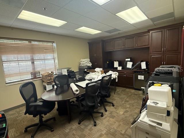 An office space features a dark wood desk, rolling chairs, and built-in cabinetry — 326 N MILLS AVENUE, ORLANDO, FL