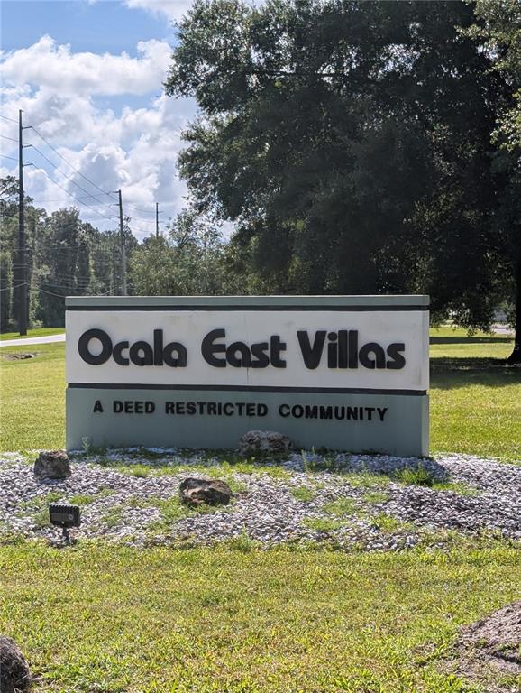 A sign for Ocala East Villas stands in a grassy area near a road — 469 NE 64TH AVENUE, OCALA, FL
