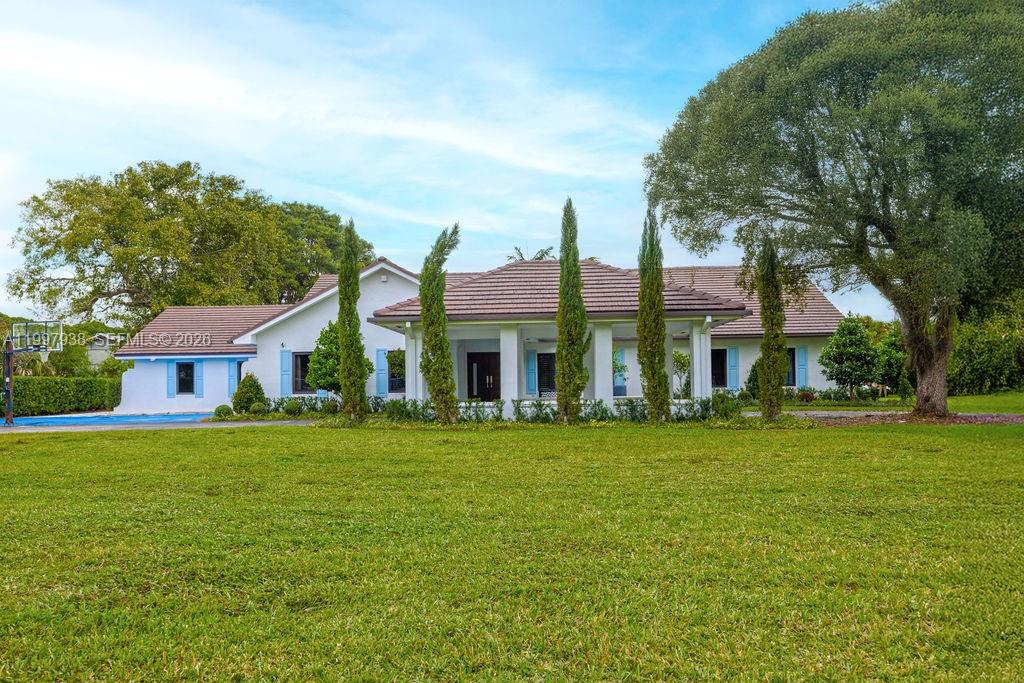 A single-story house with a brown tile roof sits behind a large green lawn — 11301 SW 95th St, Miami FL 33176, MIAMI, FL