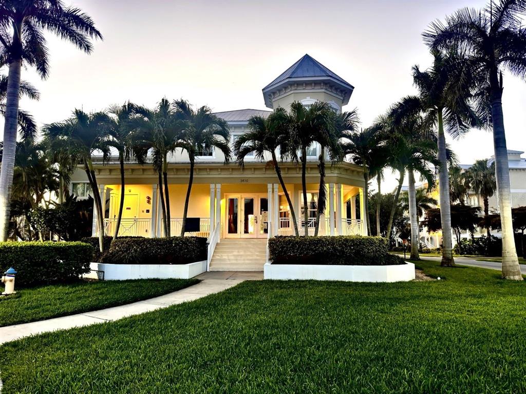 A two-story house with a wraparound porch and a central tower surrounded by palm trees — 3418 79TH STREET CIRCLE W UNIT 101, BRADENTON, FL