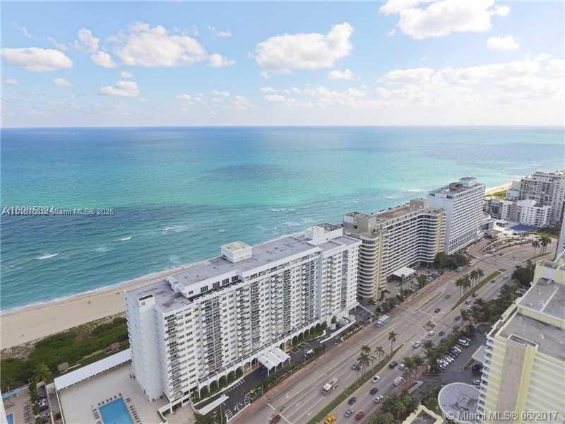 An aerial view of a coastal high-rise building next to a beach and ocean — 5601 Collins # 1210, Miami Beach FL 33140, MIAMI BEACH, FL