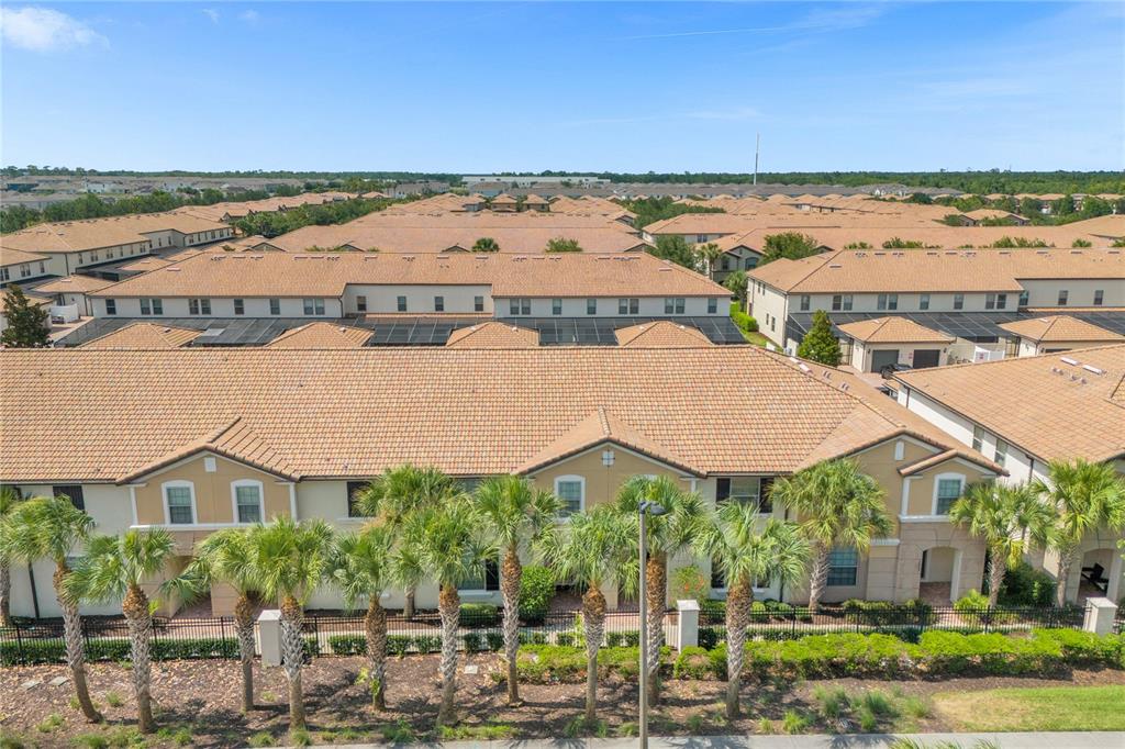 An aerial view of a multi-unit residential complex with tan stucco walls and tiled roofs — 1995 MAJORCA DRIVE, KISSIMMEE, FL
