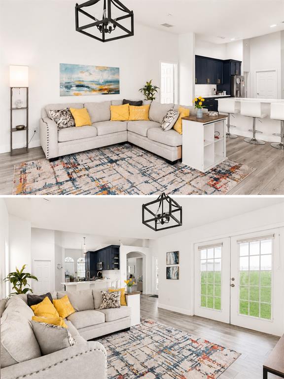 A living room with a sectional sofa, area rug, and an open kitchen with bar seating — 2526 HOLLY BERRY CIRCLE, CLERMONT, FL
