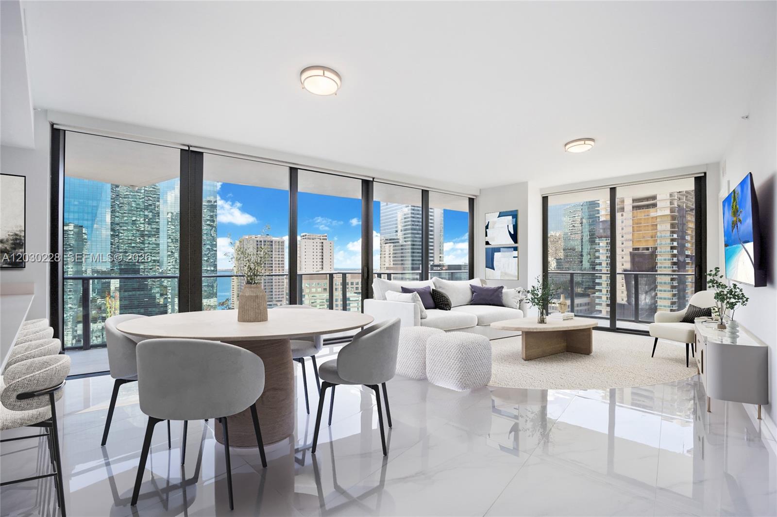 A modern living and dining area features floor-to-ceiling windows with city and water views — 1300 S Miami Ave # 1705, Miami FL 33130, MIAMI, FL