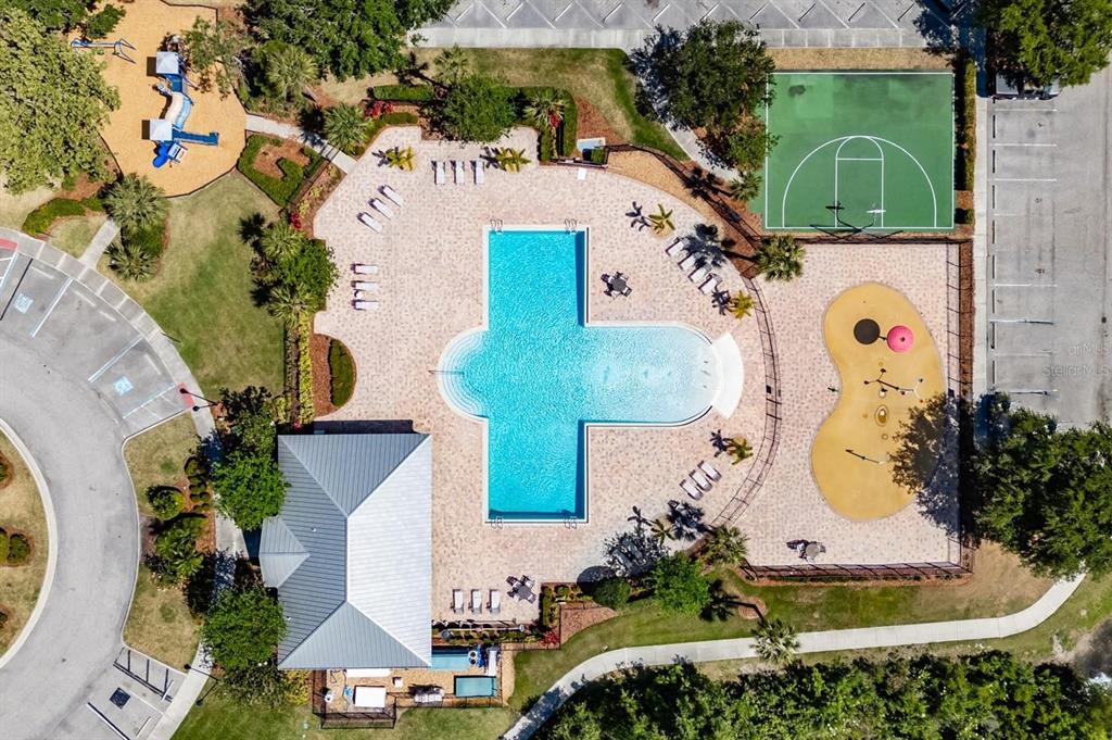 Aerial view of a community pool area with a playground, basketball court, and clubhouse — 9310 BLUEBERRY ASH CIRCLE, RIVERVIEW, FL