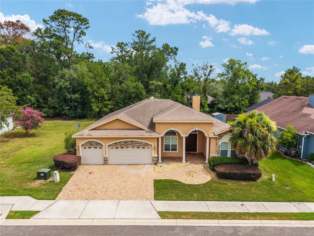An aerial view of a single-story house with a two-car garage and paved driveway — 14540 NW 27TH PLACE, NEWBERRY, FL