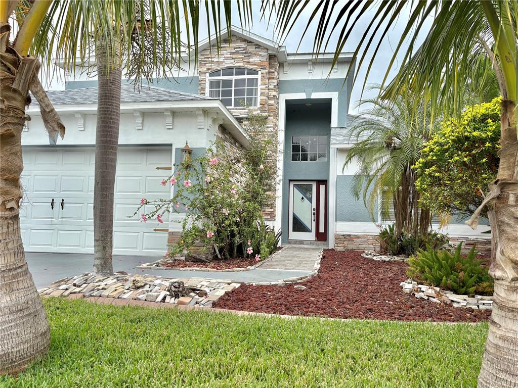 A two-story house with a stone facade, a garage, and a landscaped front yard — 6346 BOBBY JONES COURT, PALMETTO, FL