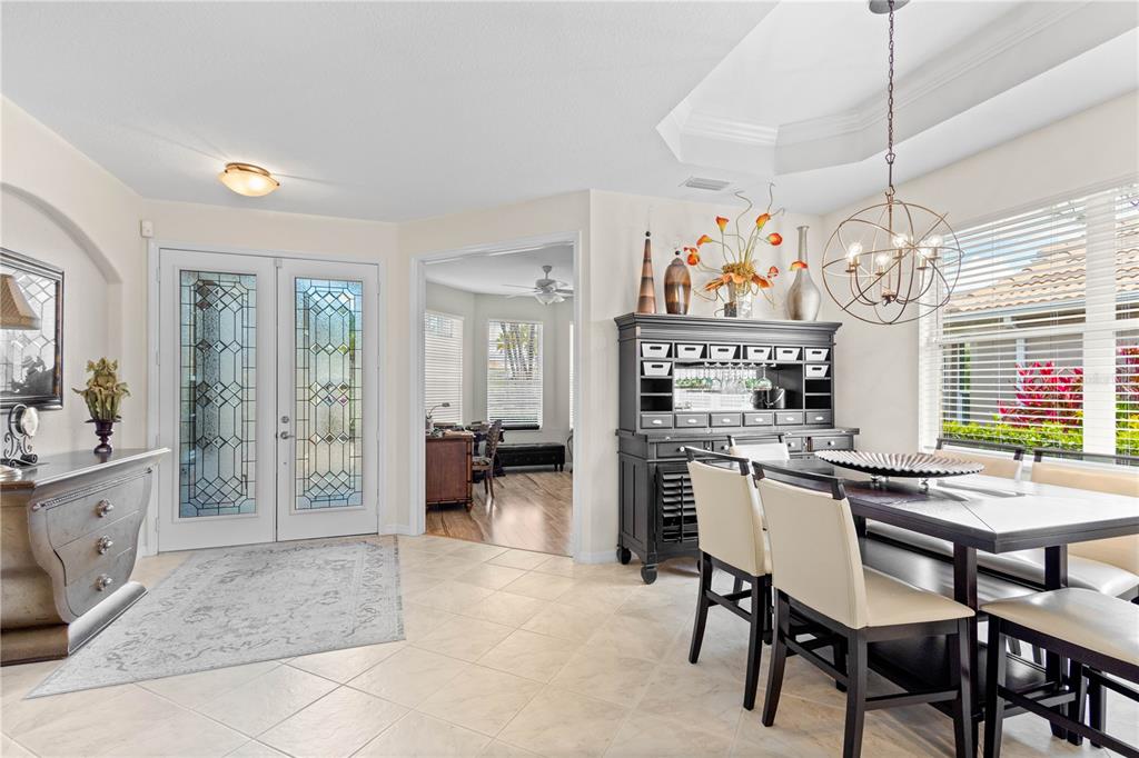 A dining area with a black hutch, a modern chandelier, and a view into an office — 5359 WHITE IBIS DRIVE, NORTH PORT, FL