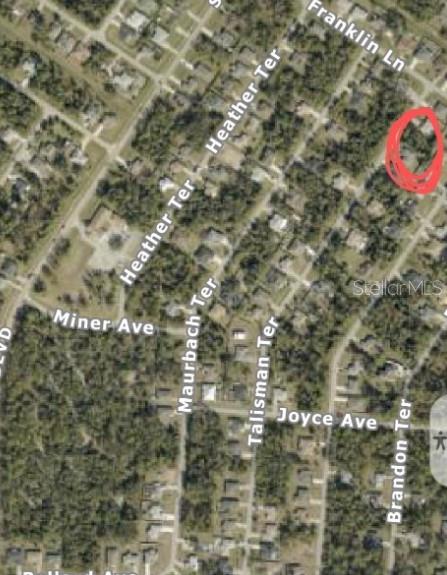 This is an aerial map view of a residential neighborhood with a property circled in red — TALISMAN TERRACE, NORTH PORT, FL