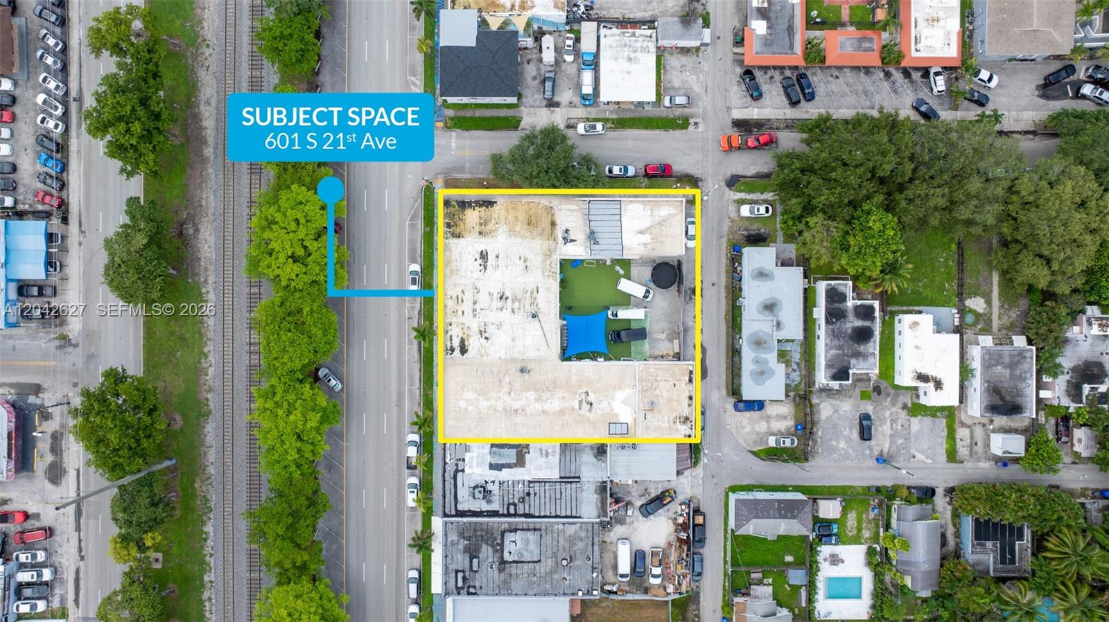 This aerial view shows a commercial building with a central courtyard and surrounding parking lots — 601 N 21st Ave, Hollywood FL 33020, HOLLYWOOD, FL