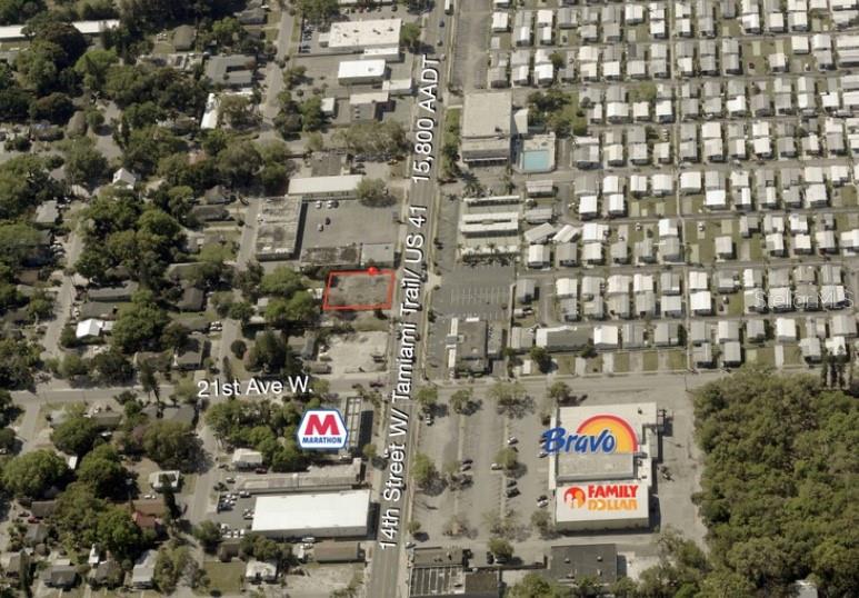 An aerial view shows a vacant rectangular lot outlined in red along a busy road — 2121 14TH STREET W, BRADENTON, FL