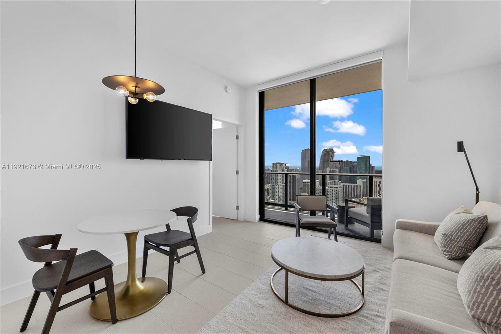 A high-rise balcony overlooks a dense city skyline and a blue bay with boats — 159 NE 6th St # 5008, Miami FL 33132, MIAMI, FL