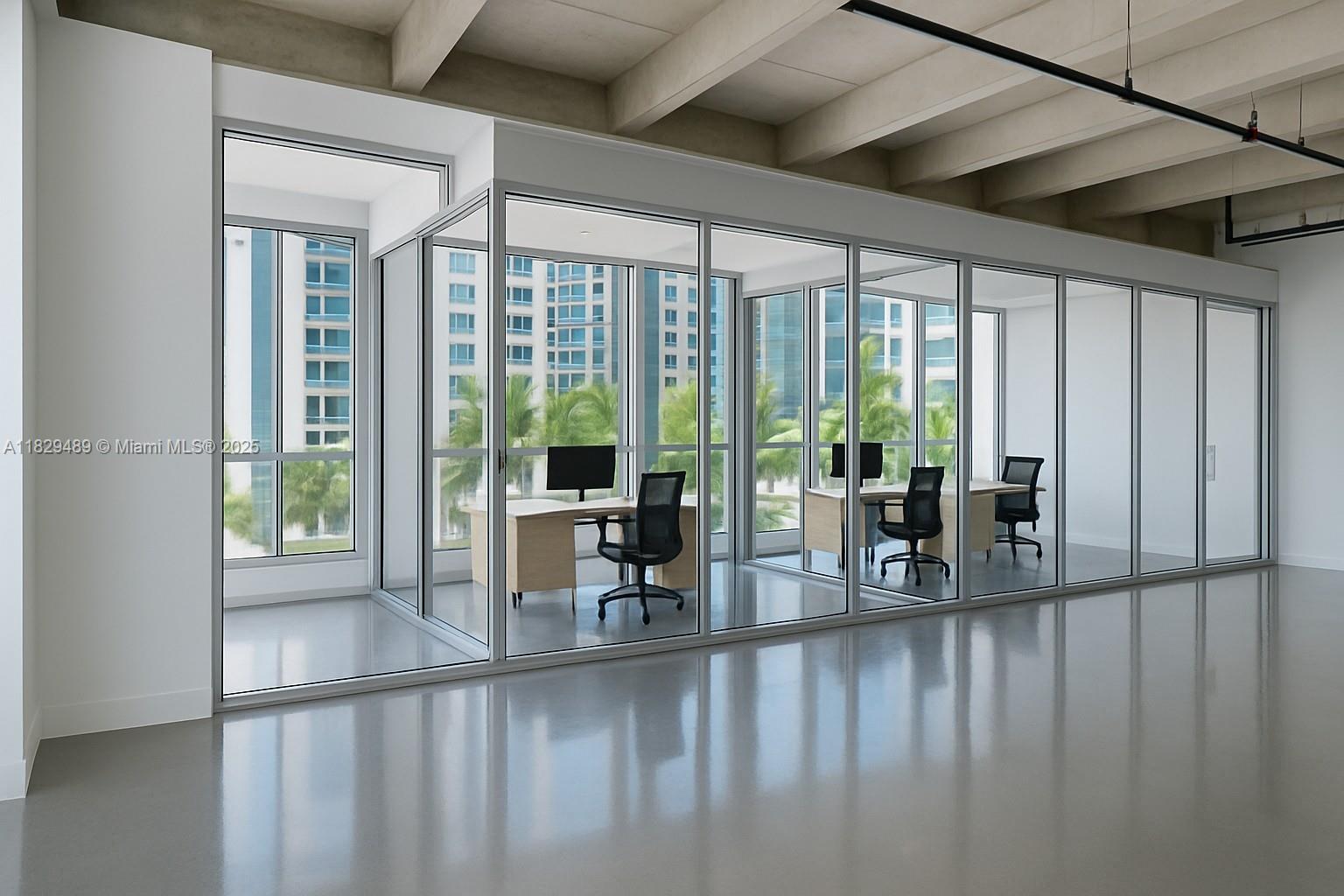 An office space features glass-walled cubicles, polished concrete floors, and exposed ceiling beams — 6930 Collins Ave, Miami Beach FL 33141, MIAMI BEACH, FL