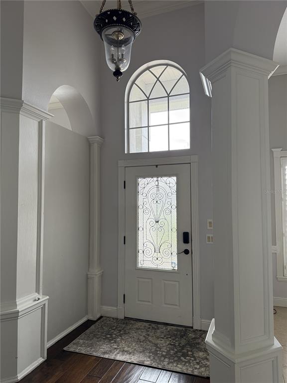 A foyer features a white front door with decorative glass, a transom window, and columns — 325 LESLIE LANE, LAKE MARY, FL
