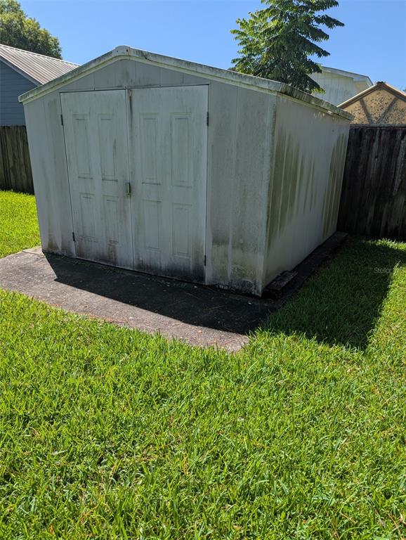 A kitchen features white cabinets, stainless steel appliances, a tile floor, and a sink — 314 ROSLYN AVENUE, NEW SMYRNA BEACH, FL
