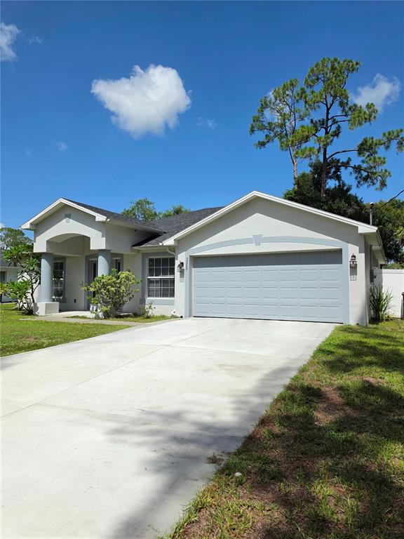 A single-story house with a two-car garage, a concrete driveway, and a covered entryway — 3369 JENNINGS STREET, NORTH PORT, FL