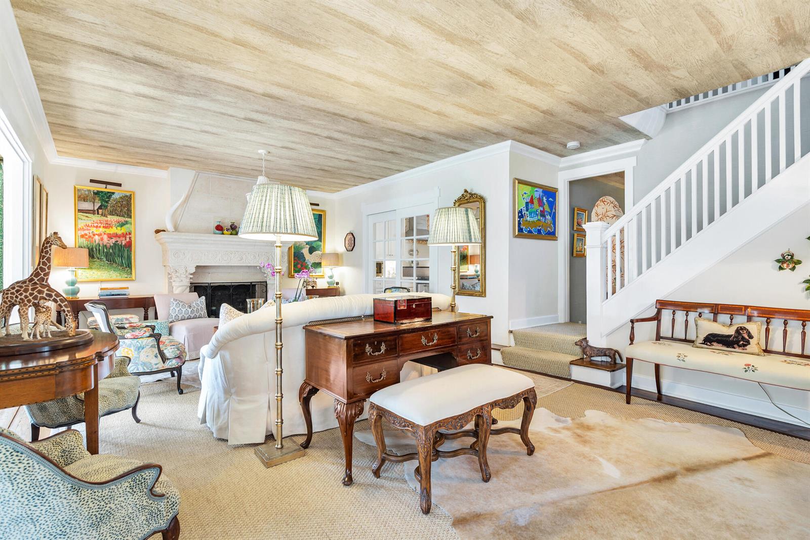 A living room features a wood-paneled ceiling, a fireplace, a staircase, and traditional furniture — 3213 Vincent Road, West Palm Beach FL 33405, WEST PALM BEACH, FL