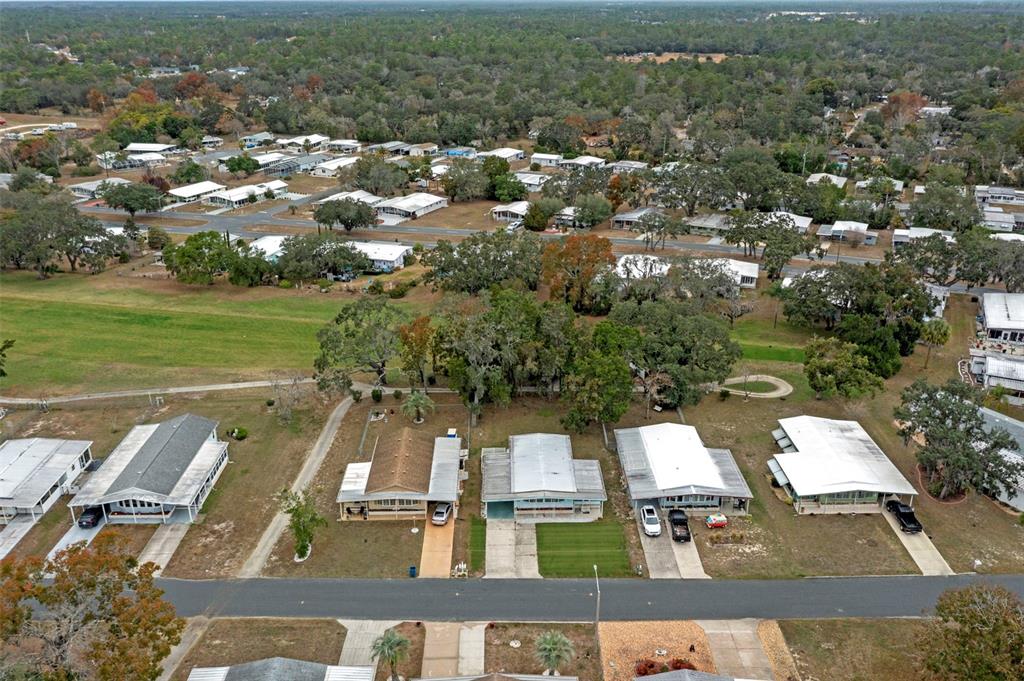 An aerial view shows a row of single-story mobile homes with driveways along a street — 12045 FORMOSA STREET, BROOKSVILLE, FL