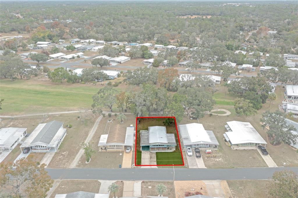 An aerial view shows a single-story house with a red outline on a residential street — 12045 FORMOSA STREET, BROOKSVILLE, FL