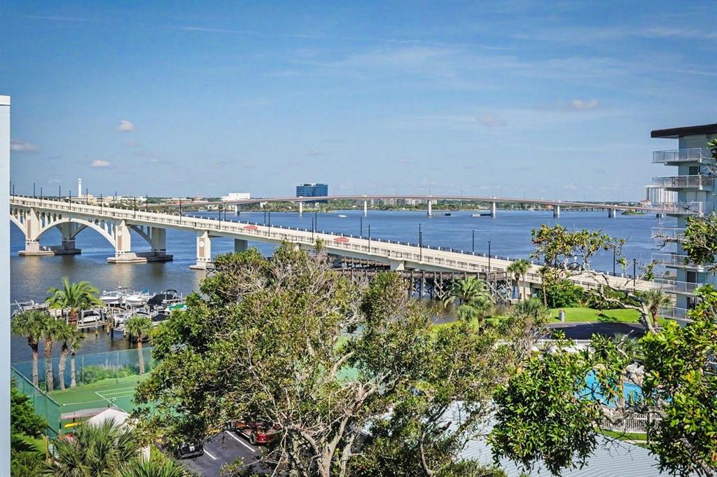 An elevated view of a bridge spanning a river with trees and buildings nearby — 1224 S PENINSULA DRIVE UNIT 621, DAYTONA BEACH, FL