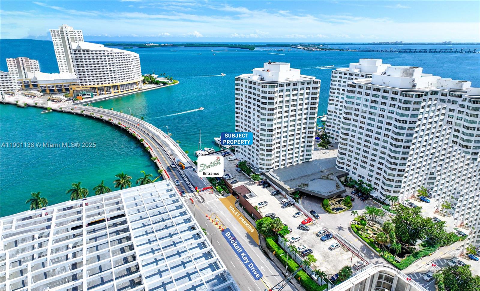 An aerial view shows high-rise residential buildings on an island connected by a bridge — 801 Brickell Bay Dr, Miami FL 33131, MIAMI, FL