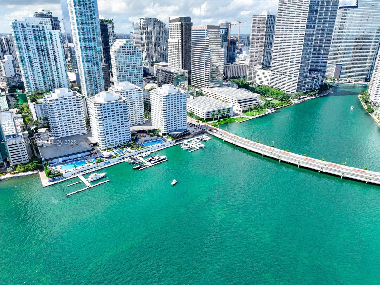 An aerial view shows a waterfront residential complex with a marina and a bridge — 801 Brickell Bay Dr, Miami FL 33131, MIAMI, FL