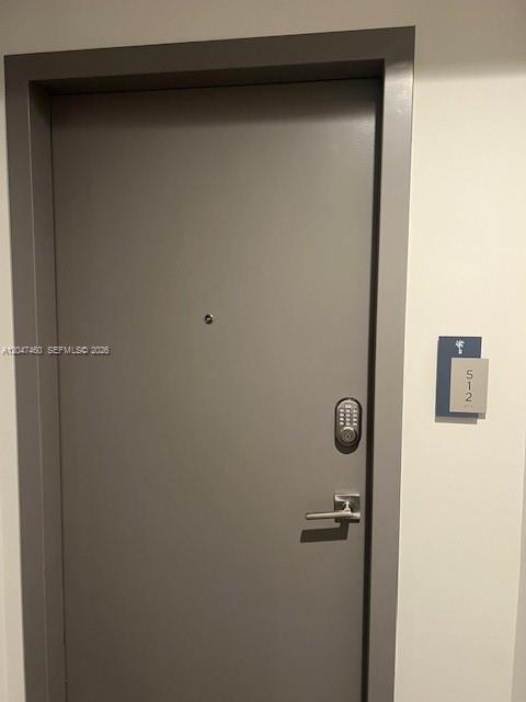 A gray apartment door with a digital keypad lock and a room number sign — 5350 NW 84th Ave # 512, Doral FL 33166, DORAL, FL