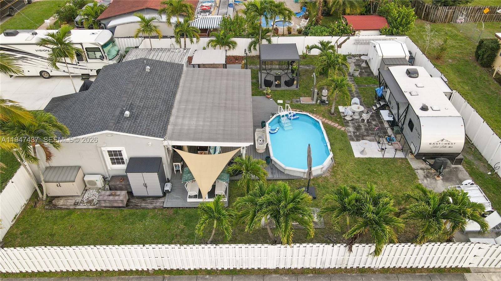 An aerial view shows a house with a pool, patio, and two parked RVs — 117 SW 6th St, Hallandale Beach FL 33009, HALLANDALE BEACH, FL