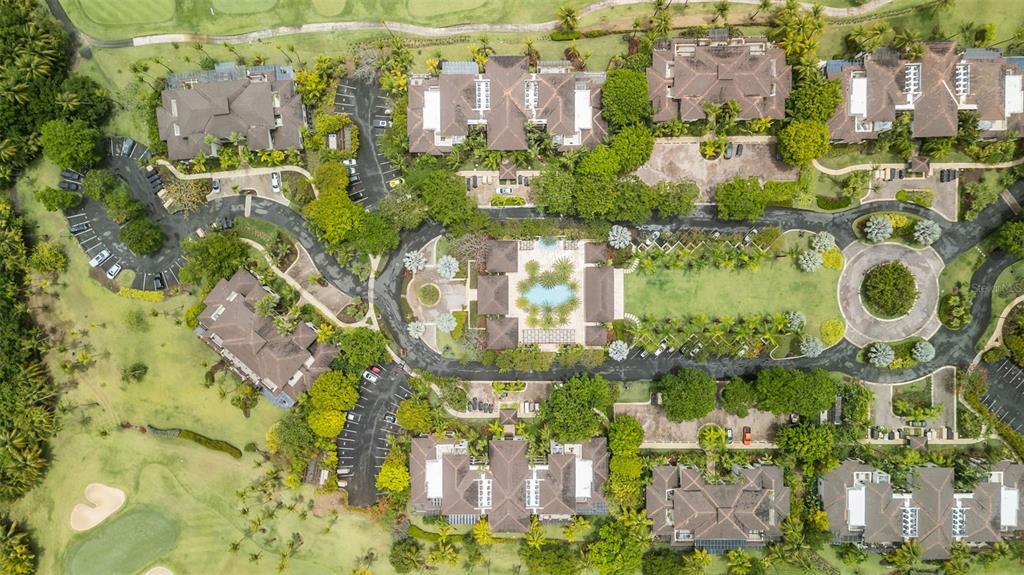 An aerial view shows a residential complex with multiple buildings, parking areas, and green spaces — 8164 LAS VERANDAS AT BAHIA BEACH RESORT UNIT 8164, RIO GRANDE, PR