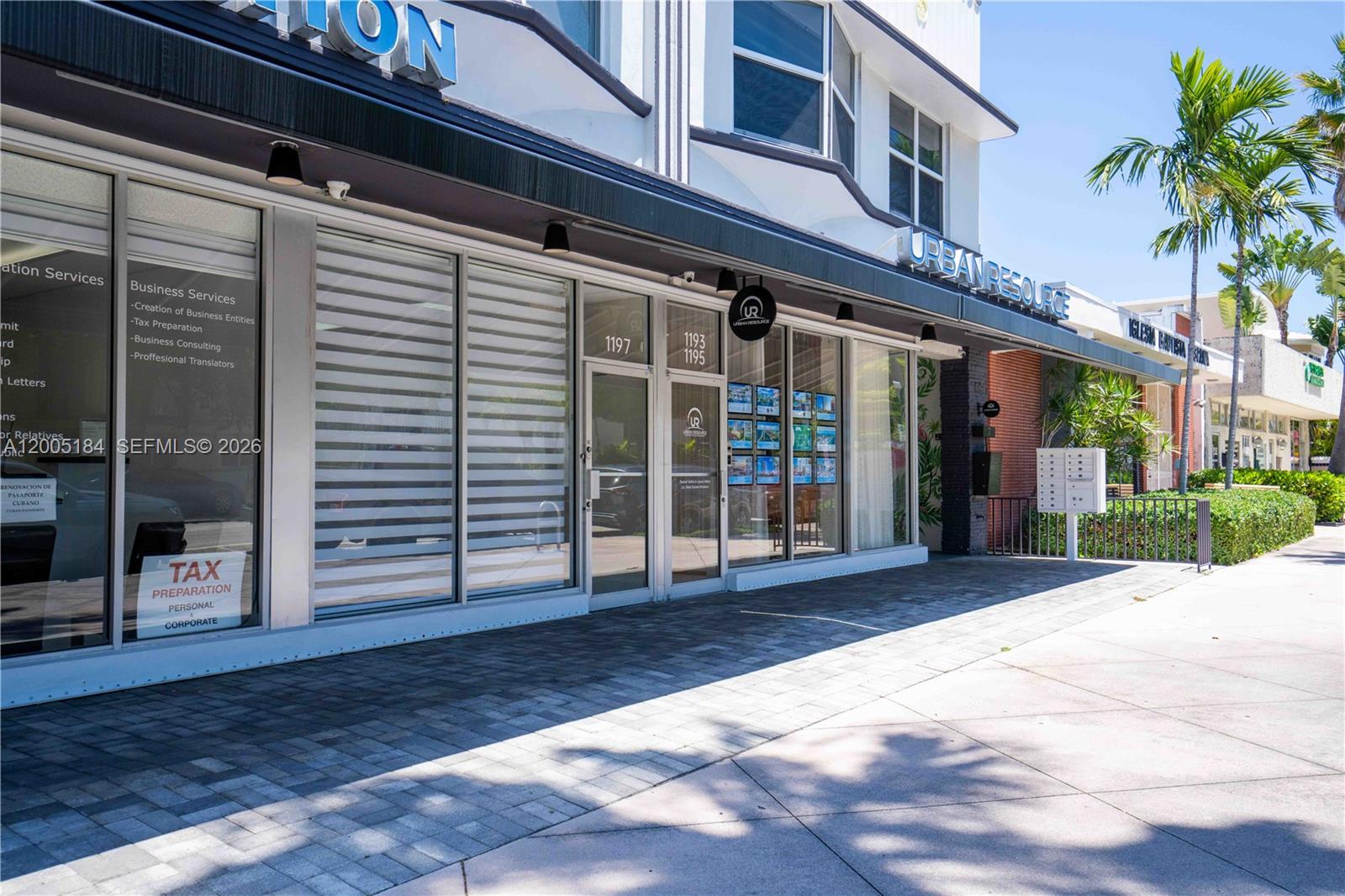 A street-level view of a commercial building exterior with glass storefronts and signage — 1197 71 St, Miami Beach FL 33141, MIAMI BEACH, FL