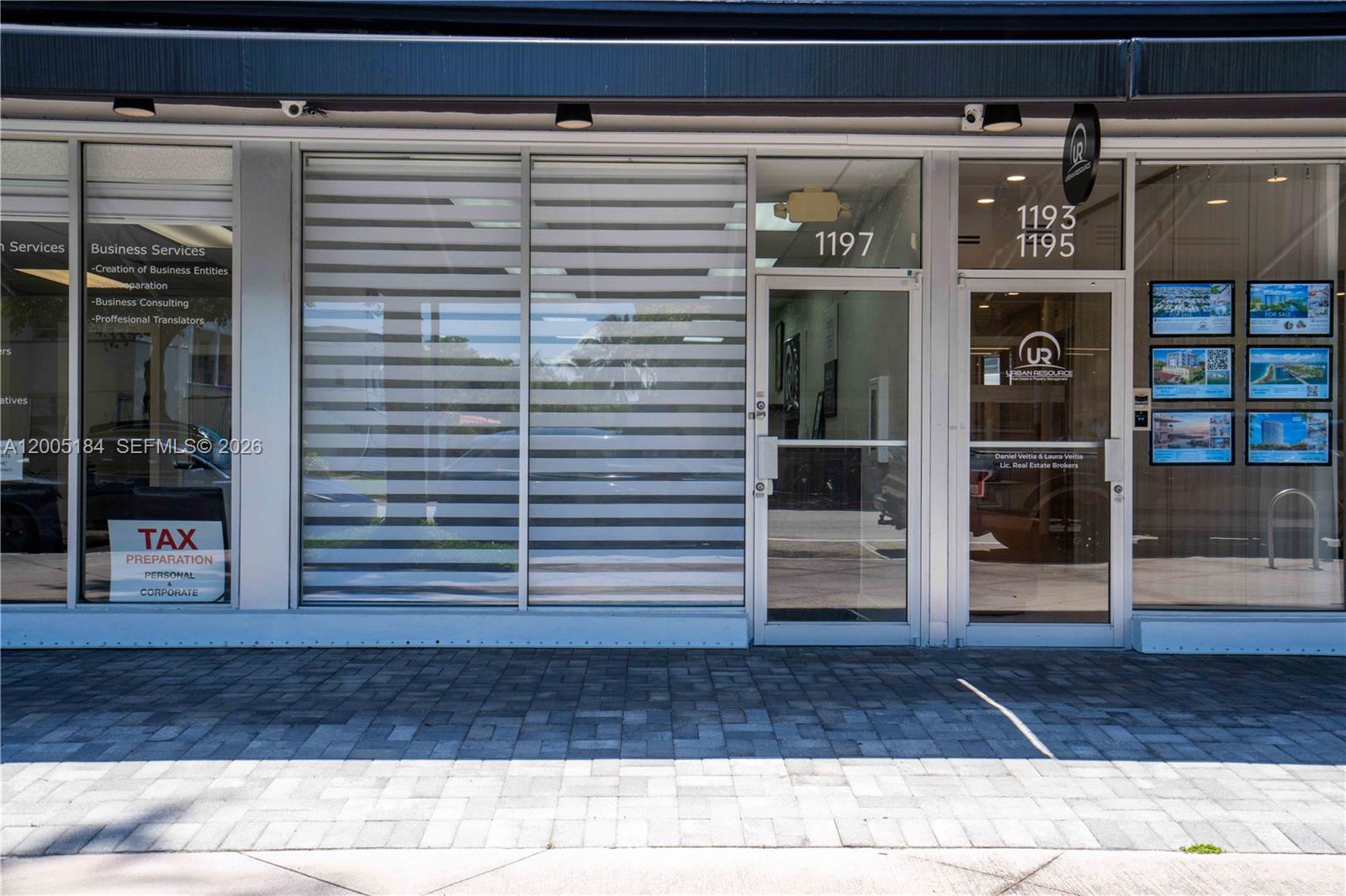 The exterior of a commercial storefront features glass doors and windows with business signage — 1197 71 St, Miami Beach FL 33141, MIAMI BEACH, FL