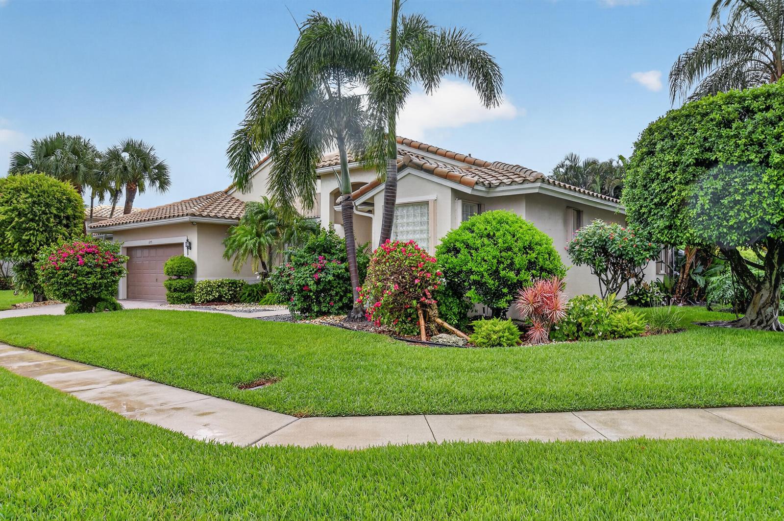A single-story house with a tile roof, palm trees, and landscaped lawn under a blue sky — 6715 Chimere Terrace, Boynton Beach FL 33437, BOYNTON BEACH, FL