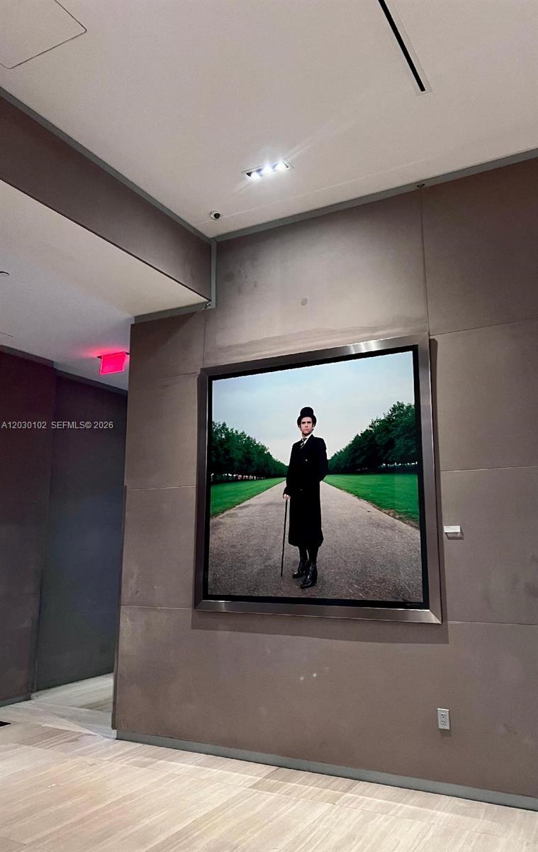 A framed photograph of a person in a top hat hangs on a gray wall — 1080 Brickell Ave # 3600, Miami FL 33131, MIAMI, FL