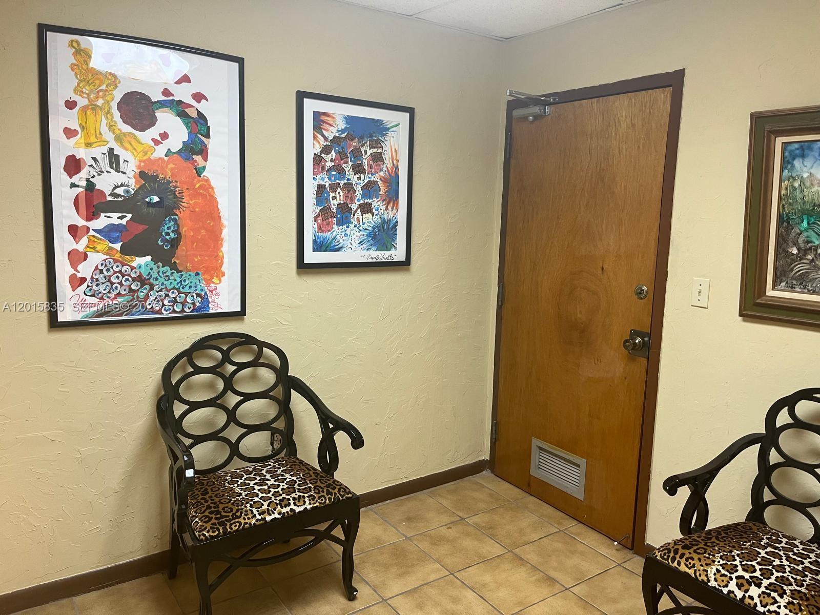 An office space features tan tile flooring, textured beige walls, and a drop ceiling — 1545 SW 1st St, Miami FL 33135, MIAMI, FL