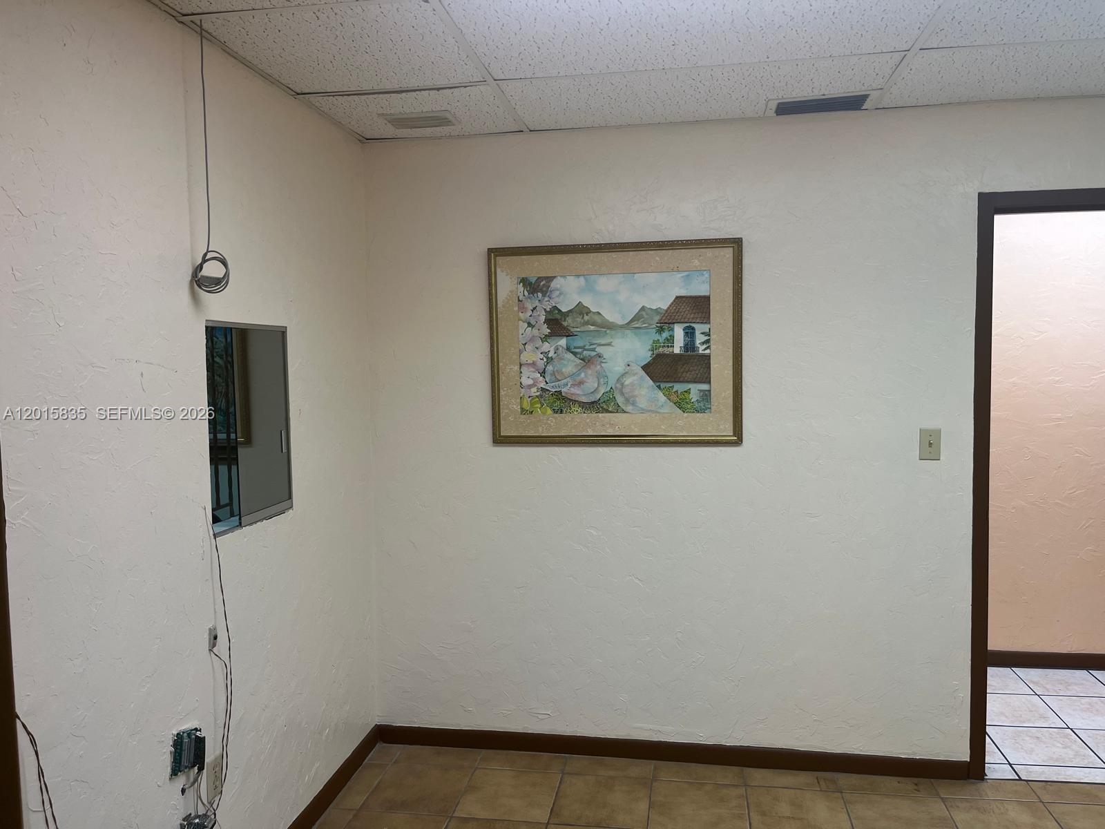 A waiting area features two leopard-print chairs, framed artwork, and a wooden door — 1545 SW 1st St, Miami FL 33135, MIAMI, FL