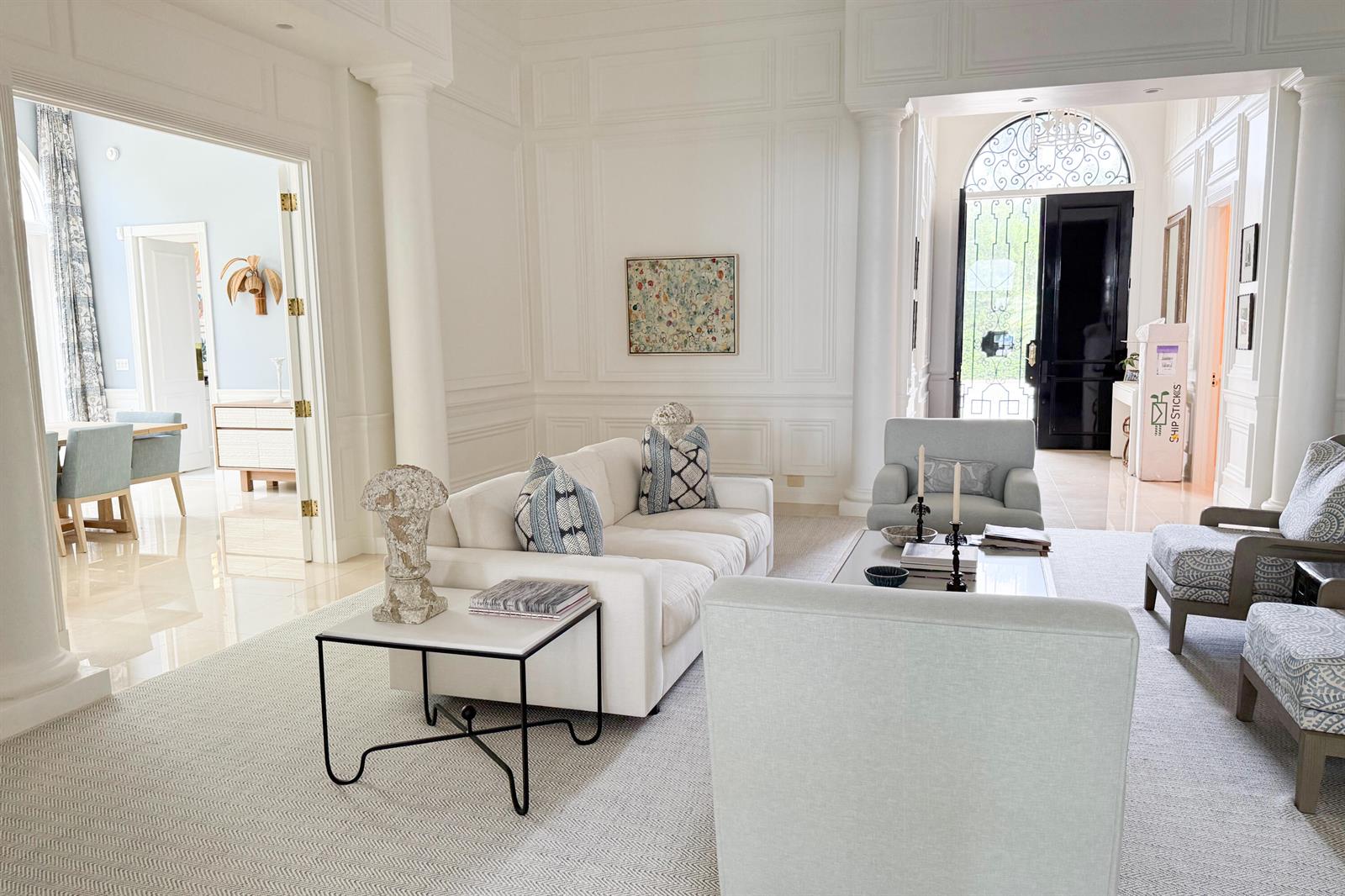 A bright, formal living room features white paneled walls, a white sofa, and patterned armchairs — 1494 N Lake Way, Palm Beach FL 33480, PALM BEACH, FL