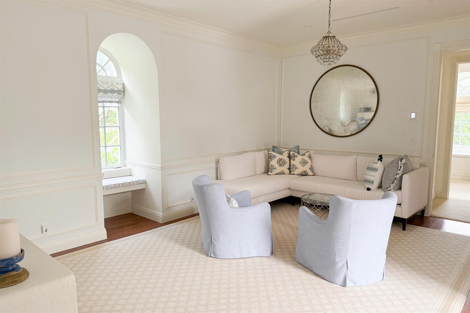 A bright living room features a white sectional, two light blue chairs, and arched windows — 1494 N Lake Way, Palm Beach FL 33480, PALM BEACH, FL