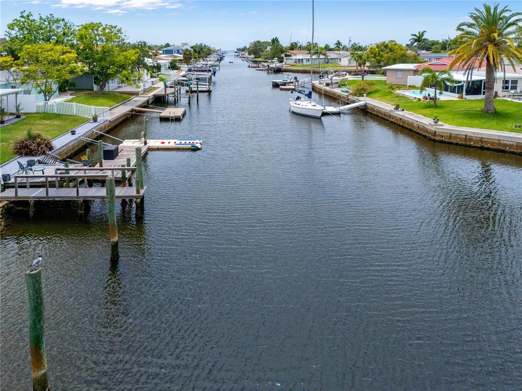 An aerial view of a residential canal lined with docks, boats, and waterfront homes — 4865 SHELL STREAM BOULEVARD, NEW PORT RICHEY, FL