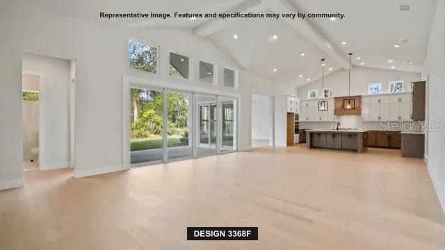 This rendering shows an open-concept living area with light wood floors and a modern kitchen — 19794 ROLLING RIDGE DRIVE, BROOKSVILLE, FL