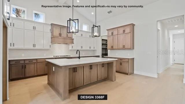 This rendering shows a kitchen with two-toned cabinetry, a large island, and pendant lighting — 19794 ROLLING RIDGE DRIVE, BROOKSVILLE, FL