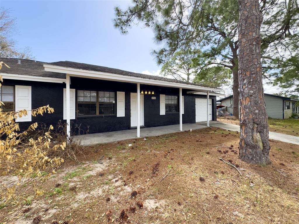A single-story house with black exterior walls, white trim, and a covered front porch — 4715 GREENHILL STREET, COCOA, FL