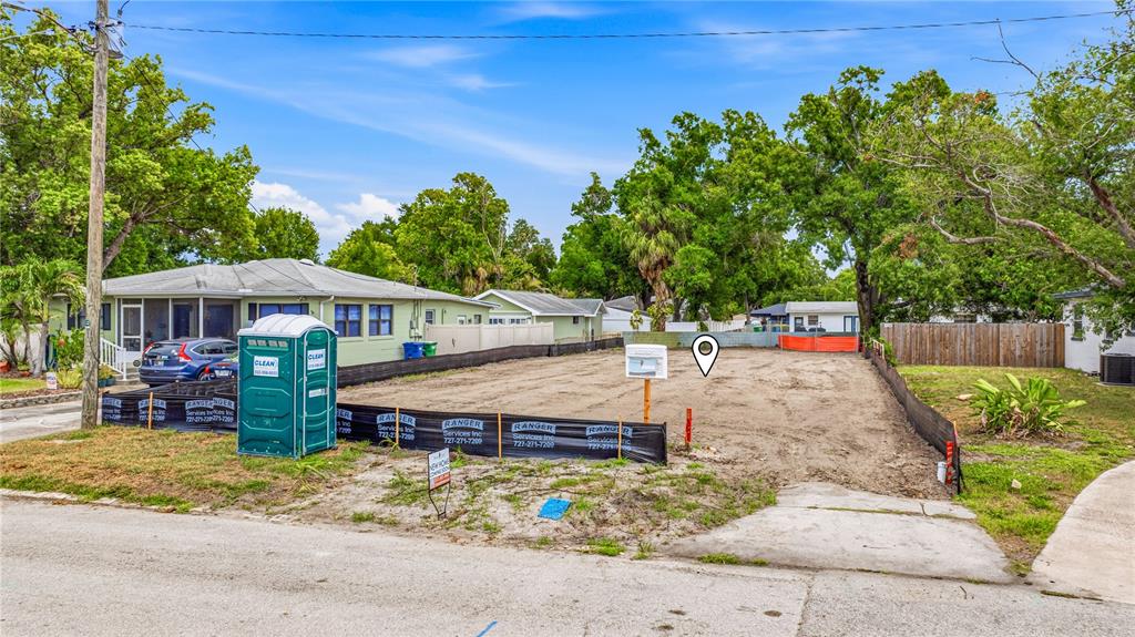 A vacant residential lot features a portable toilet and construction fencing along the street — 607 N MATANZAS AVENUE, TAMPA, FL