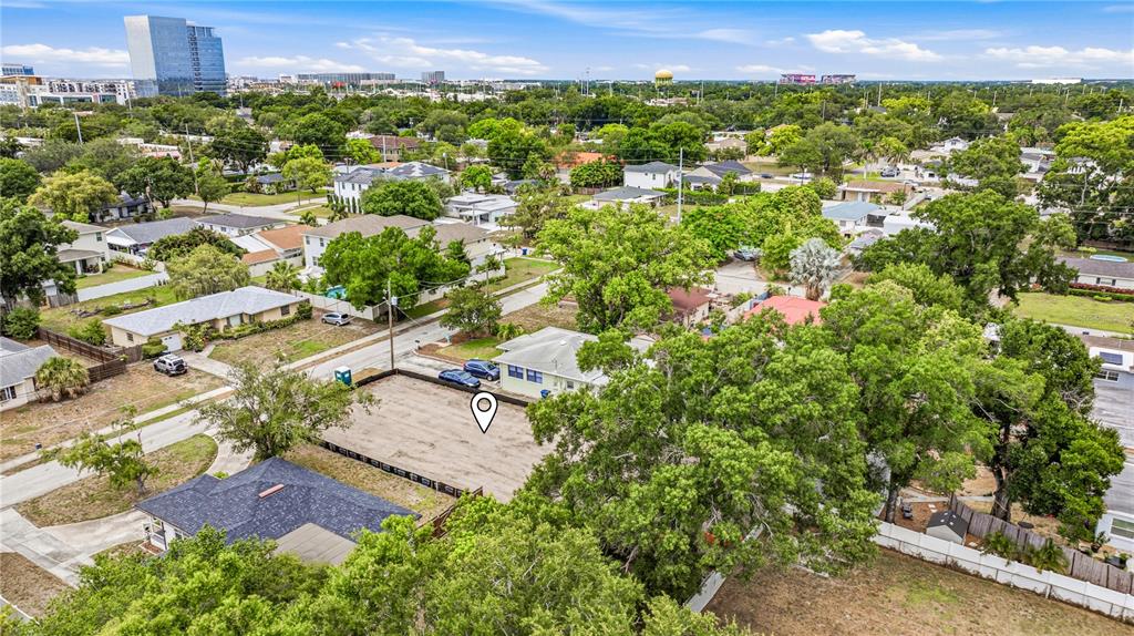An aerial view shows a vacant residential lot surrounded by houses and mature trees — 607 N MATANZAS AVENUE, TAMPA, FL