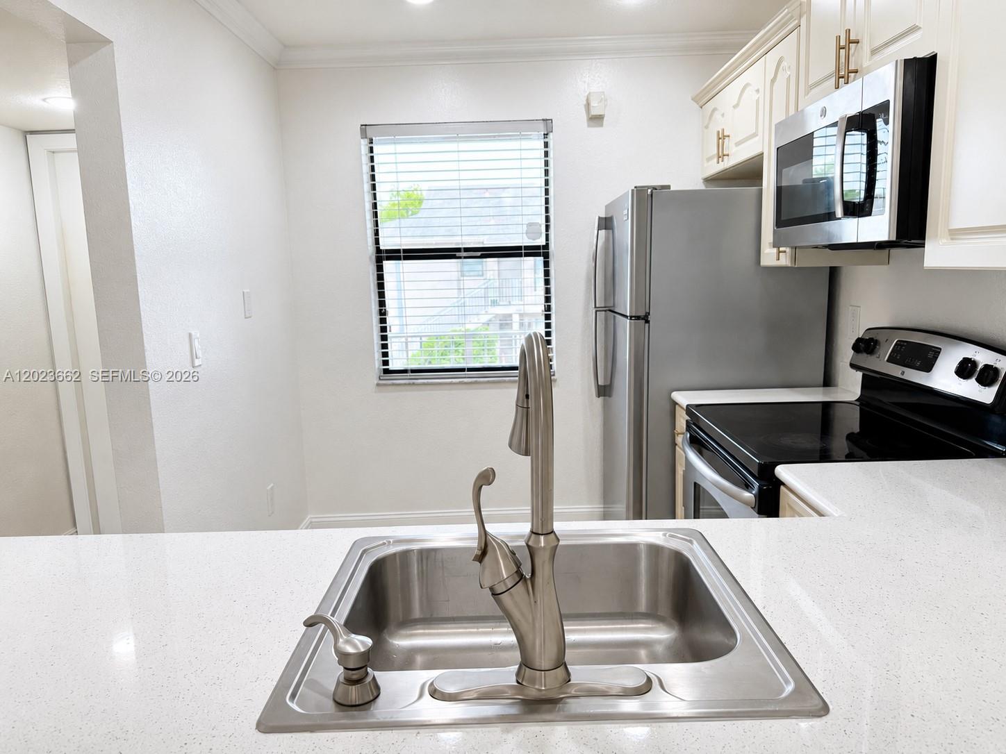 A kitchen features a stainless steel sink, white countertops, and stainless steel appliances — 7668 SW 152nd Ave # 206, Miami FL 33193, MIAMI, FL