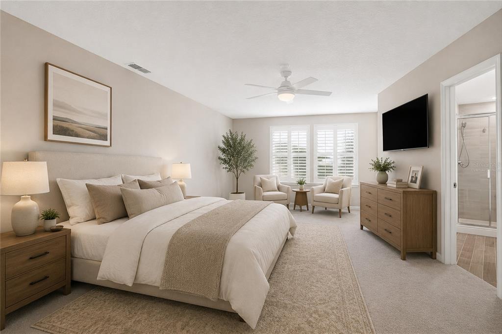 A bedroom with a king bed, two armchairs, a dresser, and an attached bathroom — 1680 POTTSBURG POINT DRIVE, JACKSONVILLE, FL