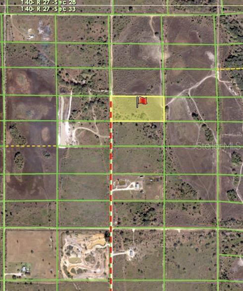 This aerial map shows a highlighted rectangular plot of land marked with a red flag — 50670 BERMONT ROAD, PUNTA GORDA, FL